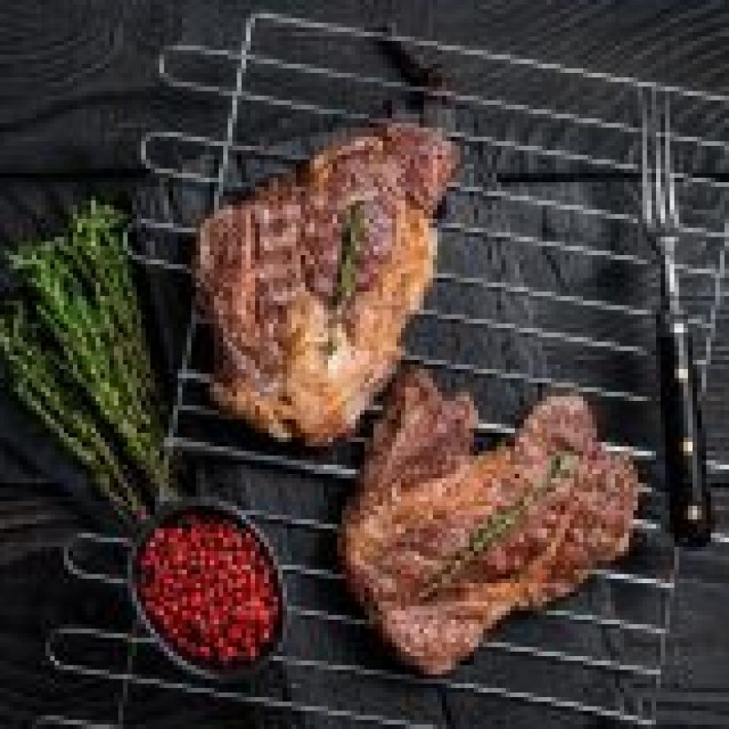bbq grilled chuck eye roll beef steaks on grill black wooden background top view.jpg